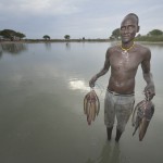 Mobil Kon displays fish he caught in Poktap, a town in South Sudan's Jonglei State where conflict, drought and inflation have caused severe food insecurity. The Lutheran World Federation, a member of the ACT Alliance, is helping families tackle food problems, including by providing cash for the purchase of fishing line and hooks. South Sudan. Photo: Paul Jeffrey/ACT