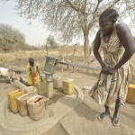 A mother and daughter draw water from a well with a hand pump in South Sudan. Photo: Paul Jeffrey/ACT