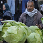 A man selling cabbages in the market of the Nuseirat refugee camp in the middle of the Gaza strip. Photo: Paul Jeffrey/ACT