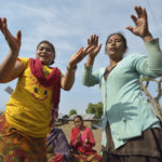 Women dance during the gathering of an emotional support group in Makaising, a village in the Gorkha District of Nepal where Dan Church Aid, a member of the ACT Alliance, has provided a variety of support to local villagers in the wake of a devastating 2015 earthquake. ACT Alliance psycho-social workers have helped villagers recover from the quake both physically and emotionally. Photo: Paul Jeffrey/ACT