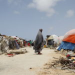 woman and tents in a refugee camp near Mogadishu